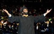 This enthusiastic student spots a familiar face in the crowd before crossing the stage. 图Chuck Thomas/ODU