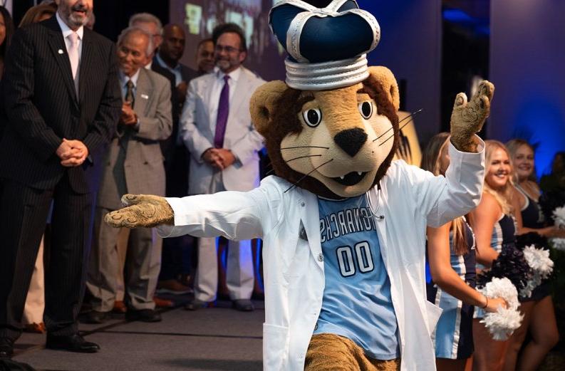 Photo of ODU's mascot dancing in front of a group of people.