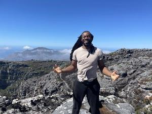 Student on top of a mountain